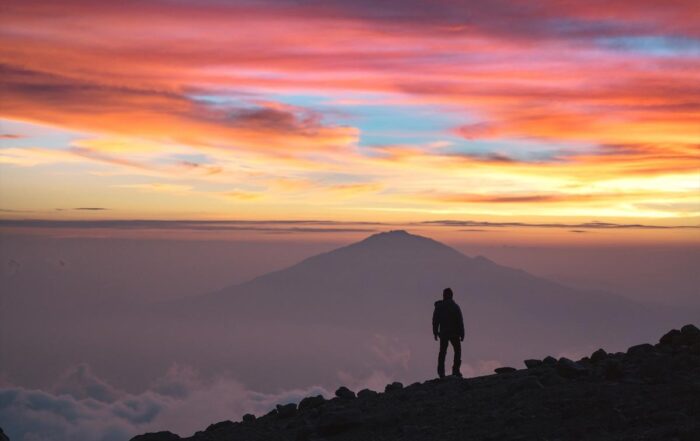 Kilimanjaro Temperature The temperature on Mount Kilimanjaro correlates with the four distinct climatic zones: The rainforest zone (800m-3,000m) is warm and humid. Densely covered with green vegetation, this zone temperatures average 12-15 °C (20-25 °C during daytime) at 2,900 m. This is where you are going to spend the first one or two days of your climb, depending on the route. The low alpine zone (3,000m-4,200m) is a semi-arid area. The higher you climb the scarcer the vegetation becomes. Depending on the route, here you will spend one or two days with average temperatures range 5-10 °C (15-20 °C during the daytime) at 3,600 m. The high alpine zone (4,200m-5,000) is desert-like. You will spend your fourth and fifth day on the Mount here, as well as the final arrangements for summiting at those altitudes. Here the temperatures average around the freezing point at 5,000m, but during the daytime, when the sun is shining, it is still quite warm and comfortable. The summit of Mount Kilimanjaro lies in the glacial zone (above 5,000m) and its temperatures average around -6 °C. However, keep in mind that all summiting attempts usually start at midnight in order to reach the Uhuru peak by dawn. You will be trekking at night when the temperature can drop to – 20°C. With harsh gusts of wind, the temperature may feel below -40 °C. However, it’s totally worth enduring the cold, because on the top you will see one of the best pictures you have ever witnessed in the light of the rising sun. Useful Information There are a few more things worth mentioning about the weather on Kilimanjaro. You may decide to climb at a less than perfect time, be it because you want to avoid the main rush or because that is the only suitable timing for your holidays. If you do so, consider the Northern Circuit Route or the Rongai Route. The northern side of the mountain is much drier than the other Kilimanjaro routes. Moreover, if you want the best weather on Kilimanjaro but hate crowds, the same applies. Choose your route wisely. There is less traffic on Rongai, Lemosho and Northern Traverse Route than on the popular (and always busy) Machame and Marangu routes.