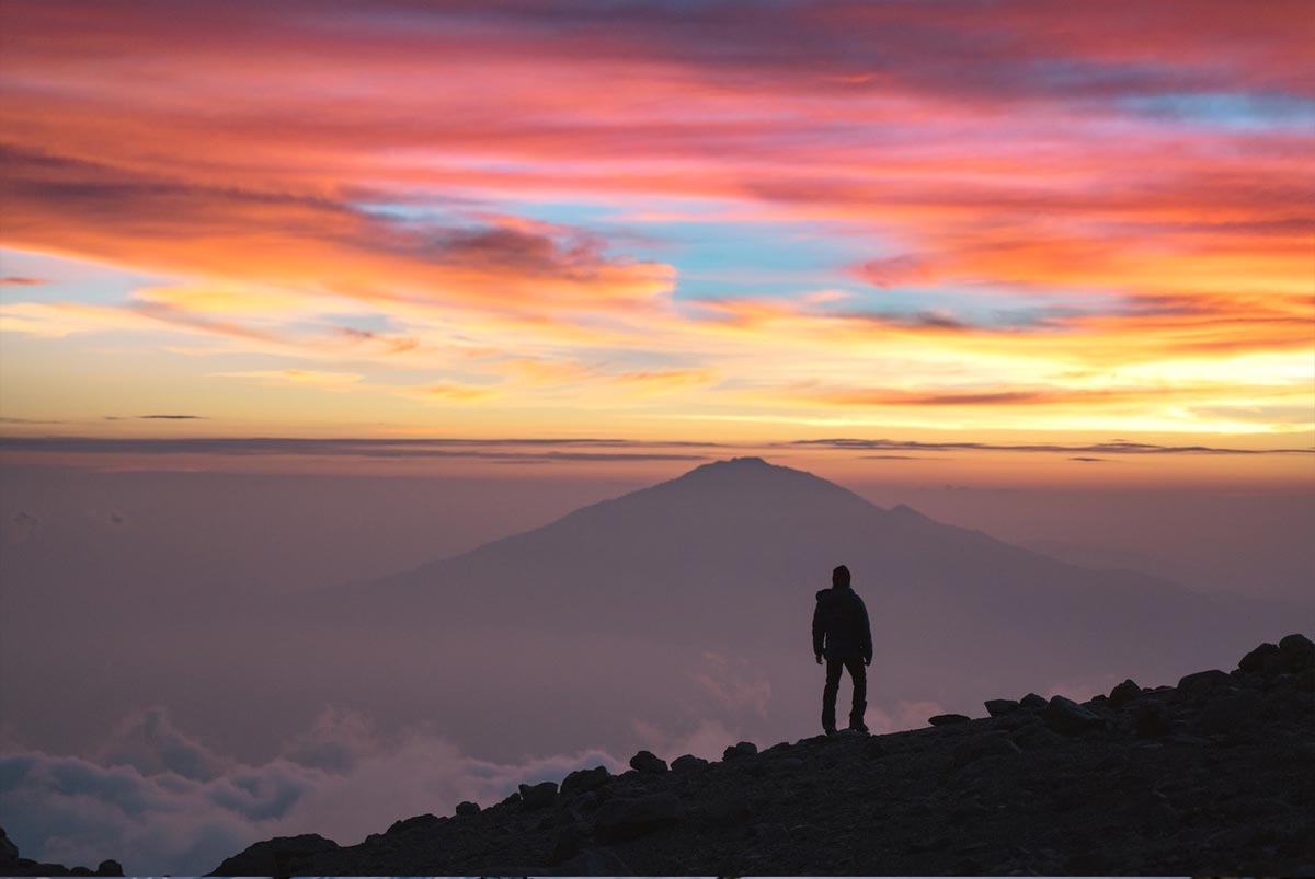 Kilimanjaro Temperature The temperature on Mount Kilimanjaro correlates with the four distinct climatic zones: The rainforest zone (800m-3,000m) is warm and humid. Densely covered with green vegetation, this zone temperatures average 12-15 °C (20-25 °C during daytime) at 2,900 m. This is where you are going to spend the first one or two days of your climb, depending on the route. The low alpine zone (3,000m-4,200m) is a semi-arid area. The higher you climb the scarcer the vegetation becomes. Depending on the route, here you will spend one or two days with average temperatures range 5-10 °C (15-20 °C during the daytime) at 3,600 m. The high alpine zone (4,200m-5,000) is desert-like. You will spend your fourth and fifth day on the Mount here, as well as the final arrangements for summiting at those altitudes. Here the temperatures average around the freezing point at 5,000m, but during the daytime, when the sun is shining, it is still quite warm and comfortable. The summit of Mount Kilimanjaro lies in the glacial zone (above 5,000m) and its temperatures average around -6 °C. However, keep in mind that all summiting attempts usually start at midnight in order to reach the Uhuru peak by dawn. You will be trekking at night when the temperature can drop to – 20°C. With harsh gusts of wind, the temperature may feel below -40 °C. However, it’s totally worth enduring the cold, because on the top you will see one of the best pictures you have ever witnessed in the light of the rising sun. Useful Information There are a few more things worth mentioning about the weather on Kilimanjaro. You may decide to climb at a less than perfect time, be it because you want to avoid the main rush or because that is the only suitable timing for your holidays. If you do so, consider the Northern Circuit Route or the Rongai Route. The northern side of the mountain is much drier than the other Kilimanjaro routes. Moreover, if you want the best weather on Kilimanjaro but hate crowds, the same applies. Choose your route wisely. There is less traffic on Rongai, Lemosho and Northern Traverse Route than on the popular (and always busy) Machame and Marangu routes.